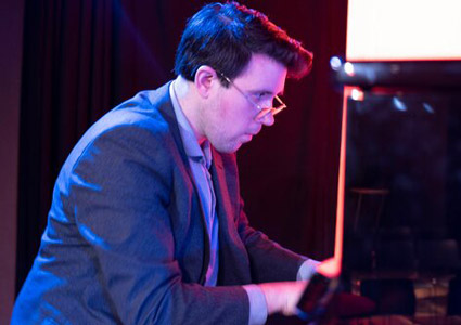 Zach Gulaboff Davis ’14 playing the piano.