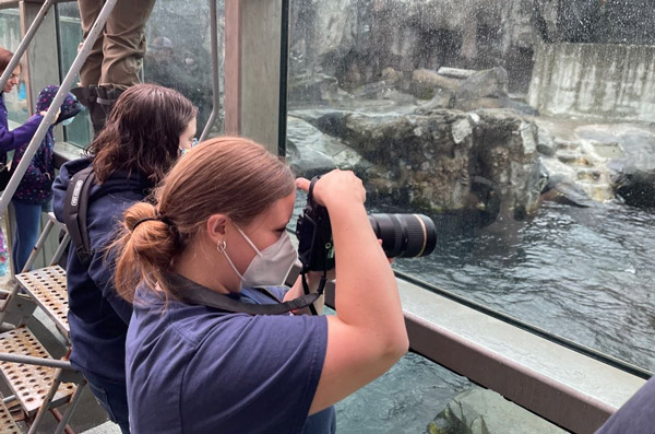 Meghan taking photos at a zoo.