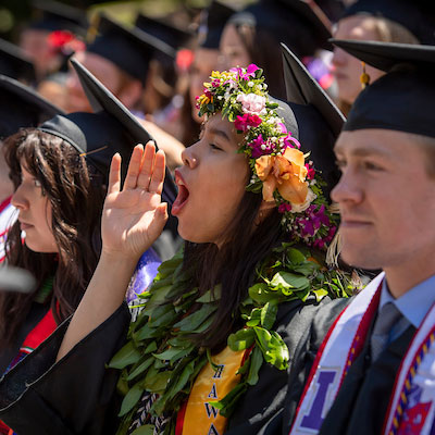 Graduate cheering for her classmates during Commencement ceremony 2022