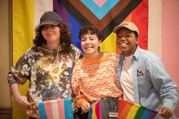 Three LUP students holding pride flags.