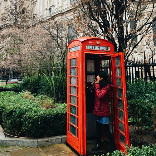 student in London phone booth