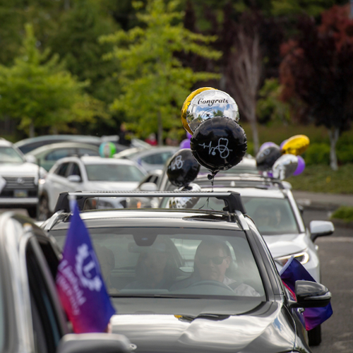 Cars in a line for Carmencement on Portland campus