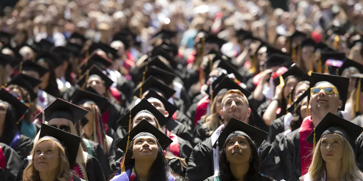 students sitting at commencement.