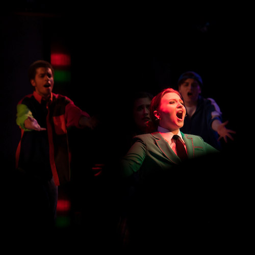 Theatre student singing in a scene from Heathers the Musical.