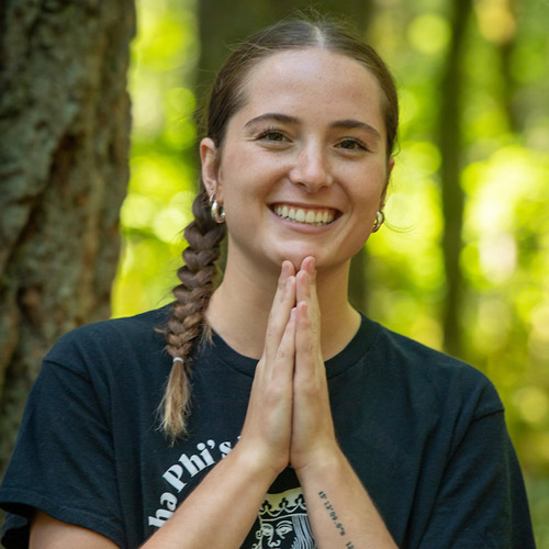 Female student with her hands in prayer position.