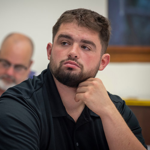 Male student listening in class.