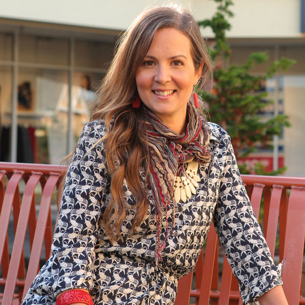 A female professional sitting on a bench outside