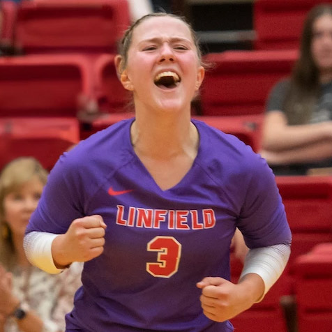 Female student-athlete celebrating after scoring in a volleyball match.