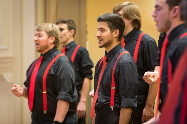 Members of Wildcat Glee performing on stage together.