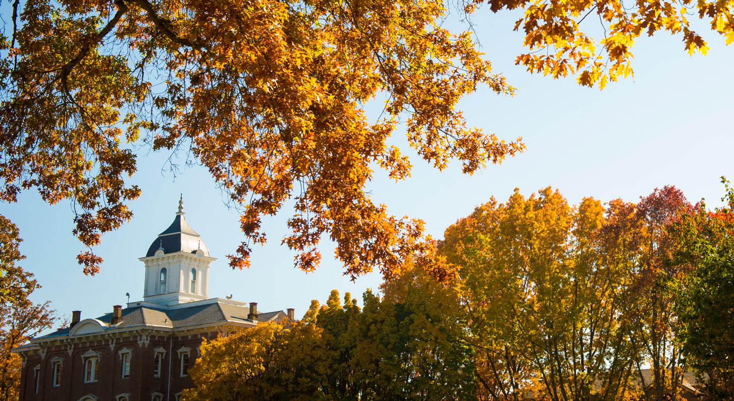 Pioneer Hall through the trees.