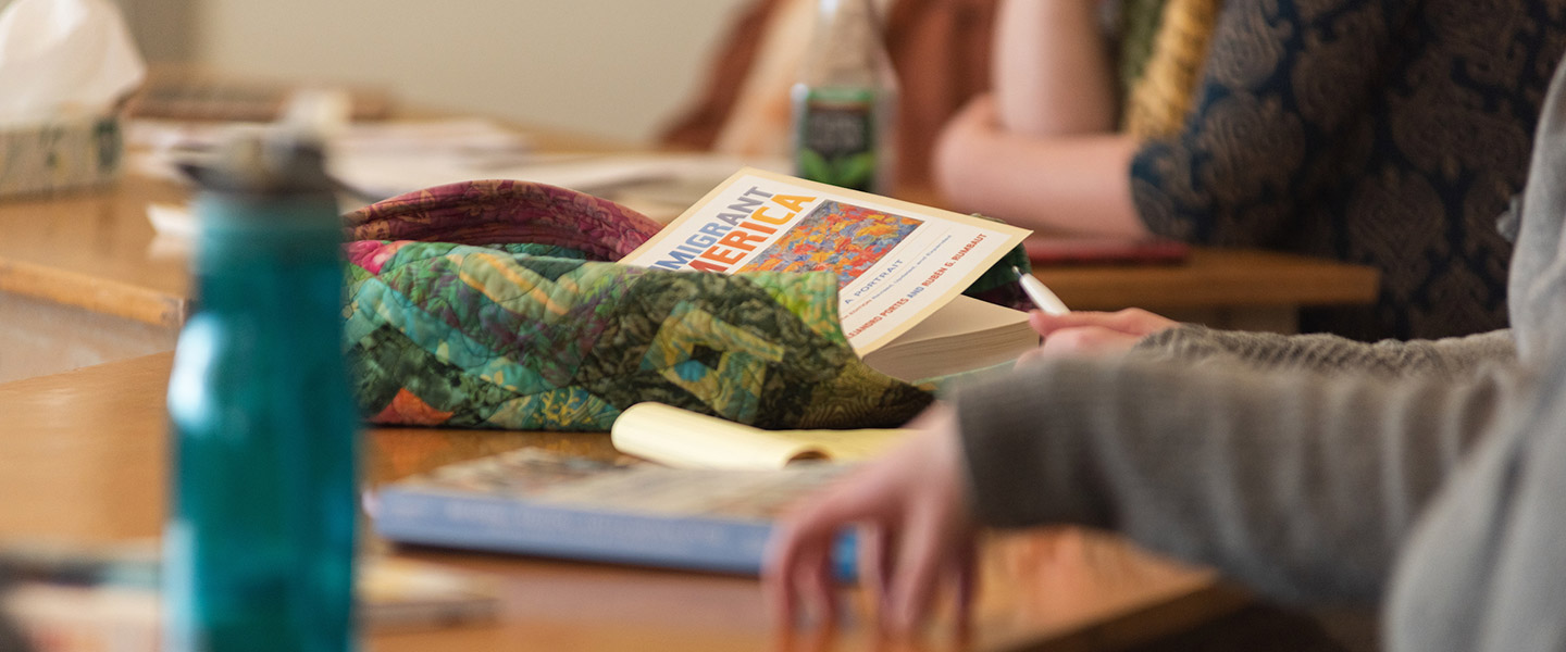 Classroom table Immigrant America book on it during ESOL class lecture