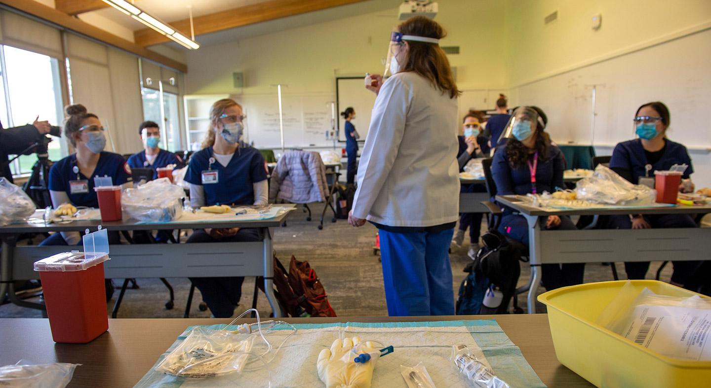 nursing students in class learning about IVs