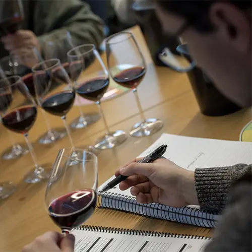 student taking notes at a wine class.